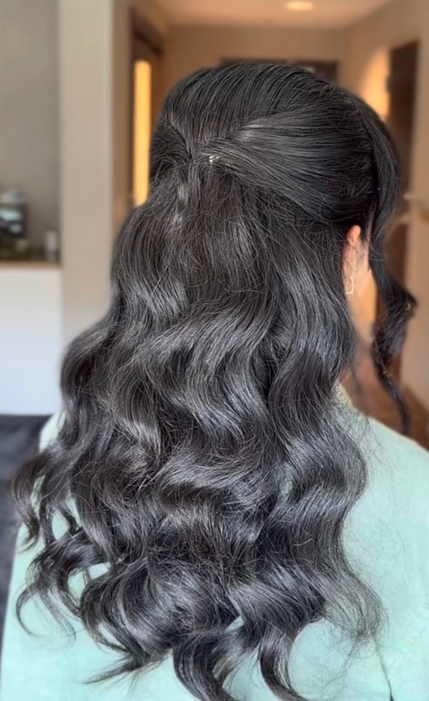 Long dark hair styled in half-up waves by @erastylist.